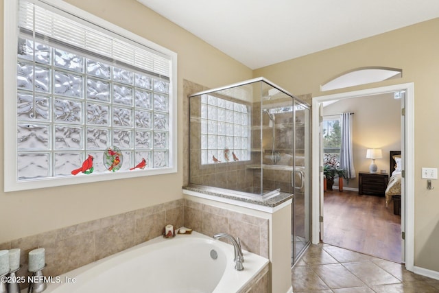 full bathroom with a stall shower, connected bathroom, a bath, and tile patterned floors