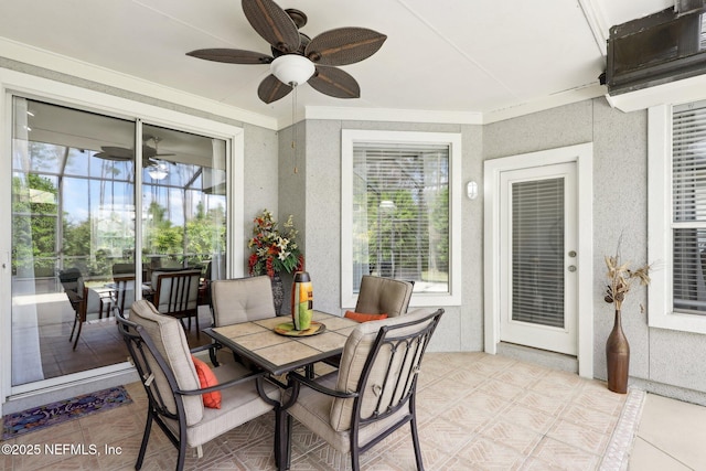 sunroom / solarium featuring a ceiling fan and a wealth of natural light