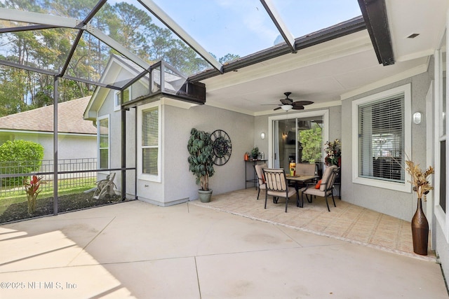 sunroom / solarium with a ceiling fan and a healthy amount of sunlight