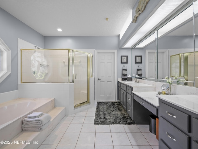 bathroom featuring a bath, a shower stall, tile patterned floors, and vanity