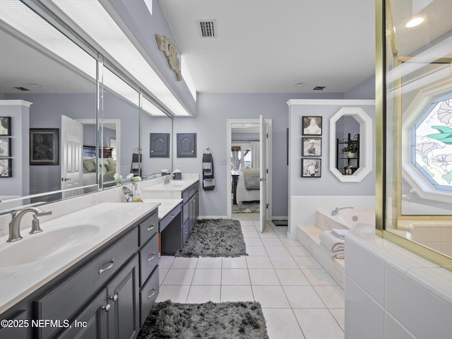 ensuite bathroom featuring visible vents, a bath, ensuite bathroom, tile patterned floors, and vanity