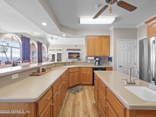 kitchen with a sink, black dishwasher, a ceiling fan, and freestanding refrigerator