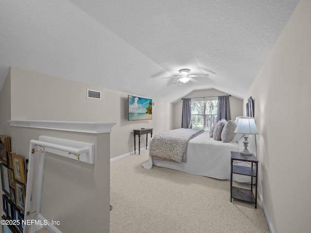 bedroom featuring baseboards, visible vents, vaulted ceiling, a textured ceiling, and carpet flooring