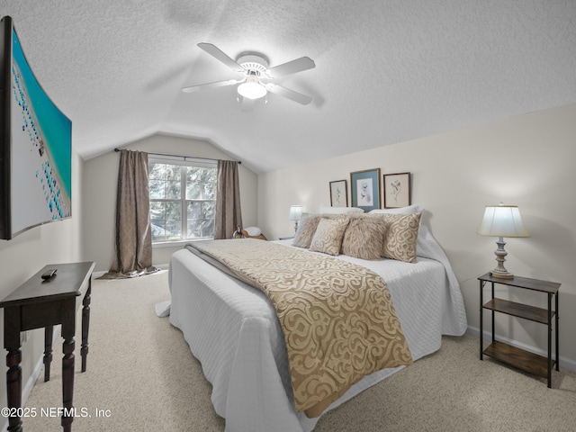 bedroom featuring baseboards, ceiling fan, vaulted ceiling, light carpet, and a textured ceiling