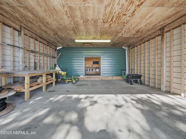 garage featuring wooden ceiling and metal wall