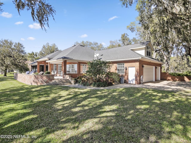 exterior space featuring a yard, brick siding, and concrete driveway