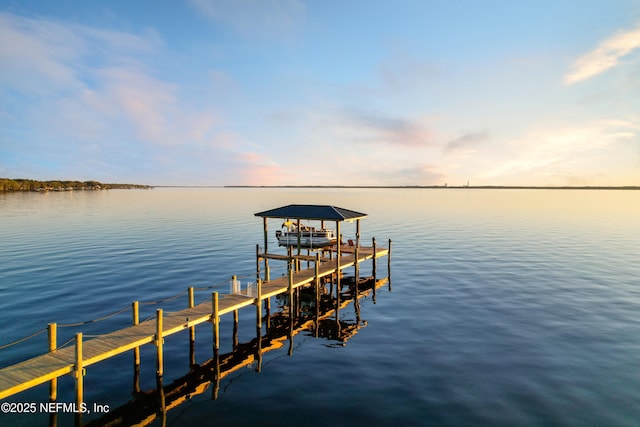 dock area featuring boat lift and a water view