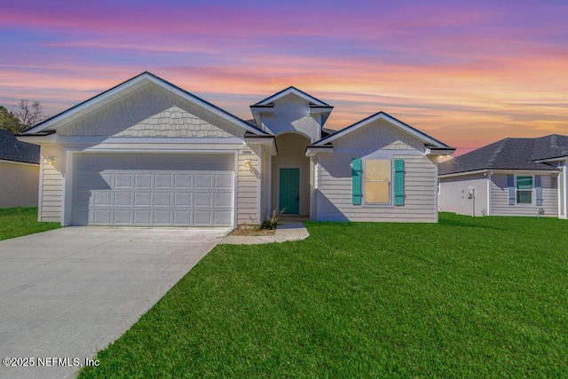 view of front of property featuring an attached garage, driveway, and a front lawn