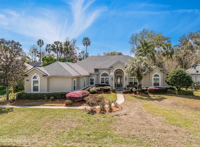 view of front of house featuring a front lawn and stucco siding