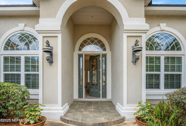 property entrance with stucco siding