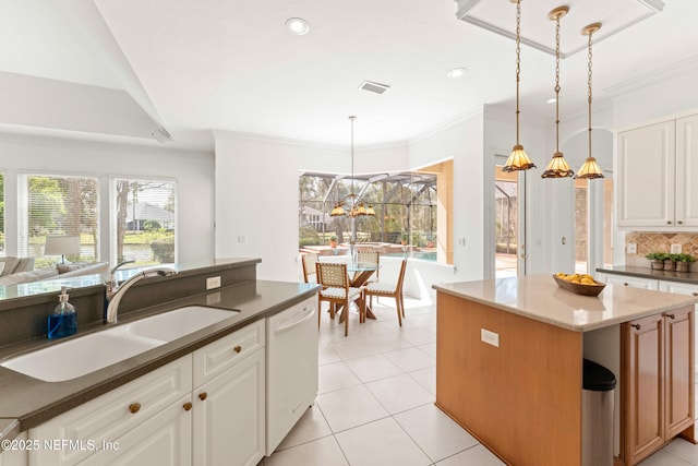 kitchen featuring light tile patterned floors, visible vents, a sink, white dishwasher, and backsplash