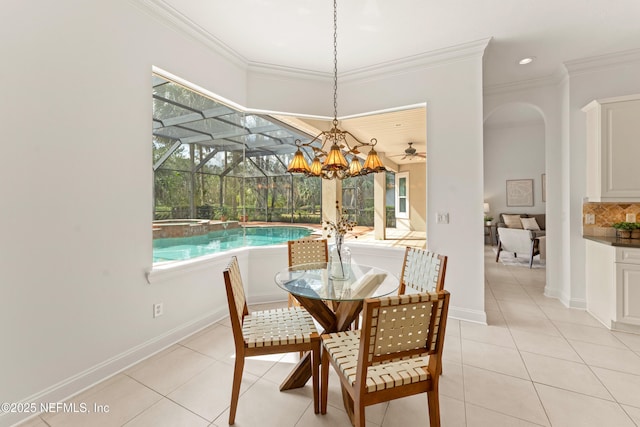 dining space with a sunroom, crown molding, and light tile patterned floors