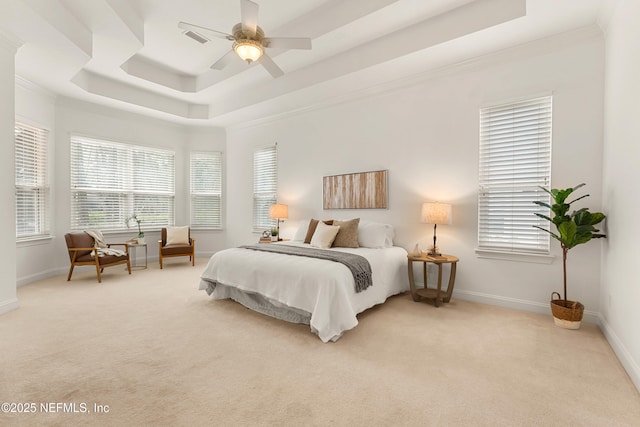 bedroom featuring a tray ceiling, light carpet, visible vents, and baseboards