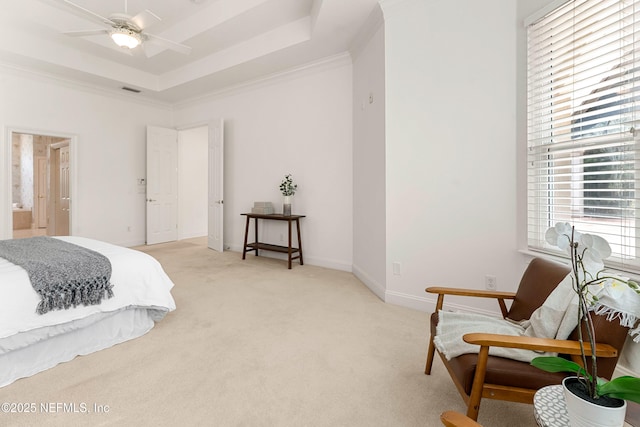 bedroom featuring light carpet, visible vents, baseboards, ornamental molding, and a raised ceiling