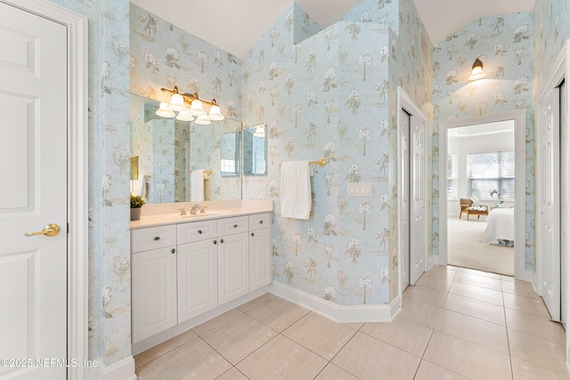 bathroom with wallpapered walls, baseboards, and tile patterned floors