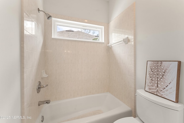 bathroom featuring toilet and  shower combination