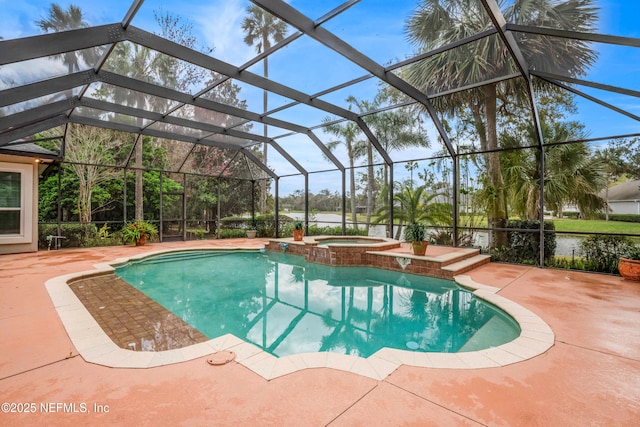 view of swimming pool featuring glass enclosure, a patio area, and a pool with connected hot tub