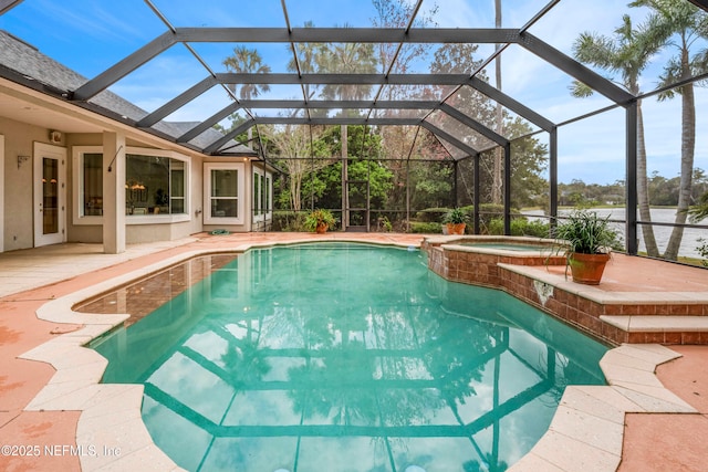 view of swimming pool featuring a lanai, a pool with connected hot tub, and a patio