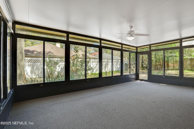 unfurnished sunroom featuring ceiling fan