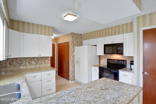 kitchen featuring white cabinetry, a textured ceiling, light stone countertops, black appliances, and wallpapered walls