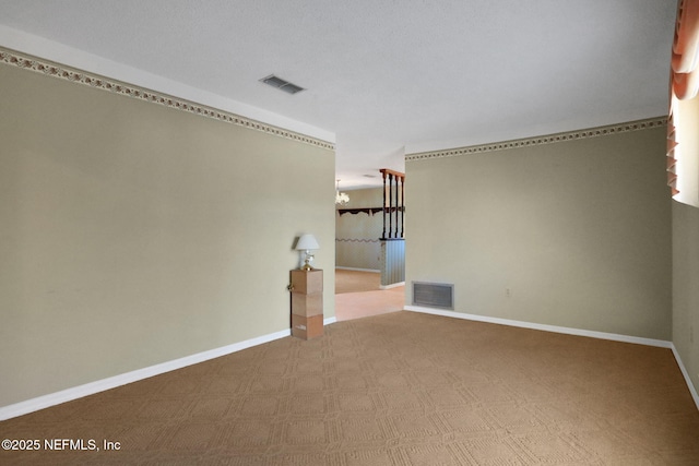 unfurnished room with visible vents and baseboards