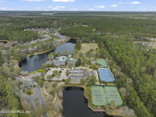 aerial view with a forest view and a water view