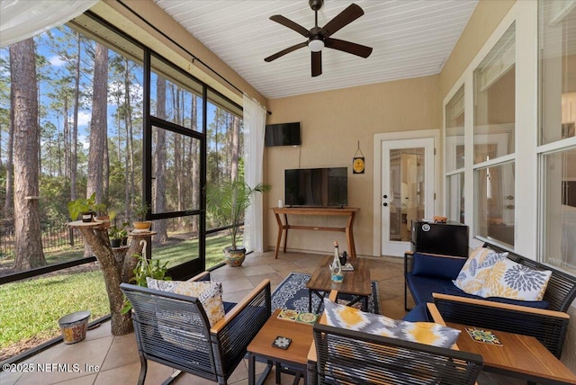 sunroom with a ceiling fan