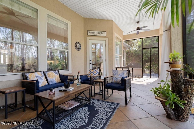 sunroom / solarium featuring a ceiling fan