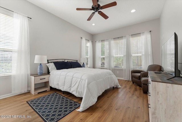 bedroom with light wood-style floors, recessed lighting, multiple windows, and ceiling fan