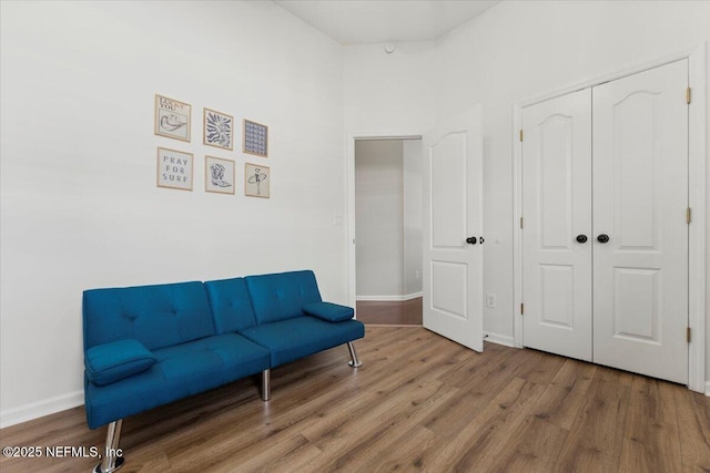 living area featuring baseboards and wood finished floors