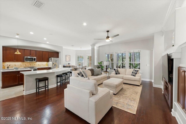 living room with baseboards, visible vents, a ceiling fan, wood finished floors, and recessed lighting