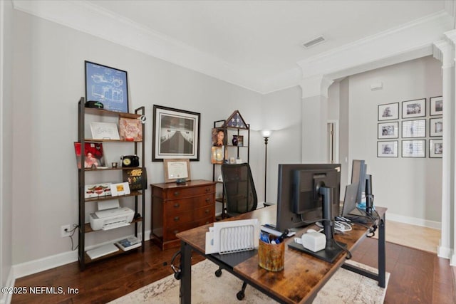 office space with visible vents, decorative columns, and wood finished floors