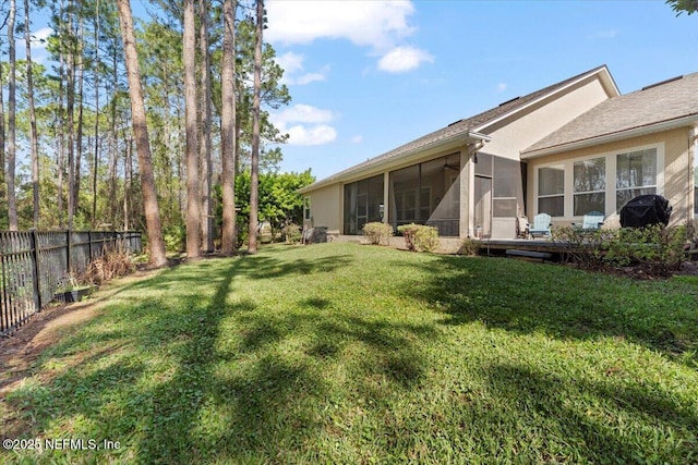 view of yard featuring a sunroom and fence