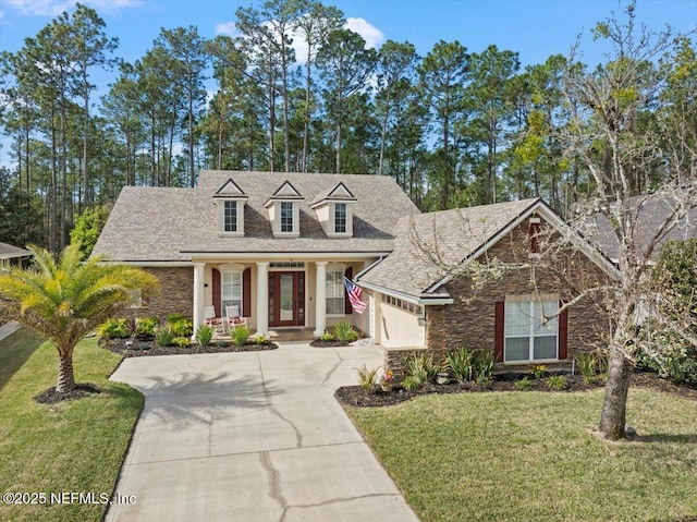 view of front of house featuring a garage, concrete driveway, and a front yard