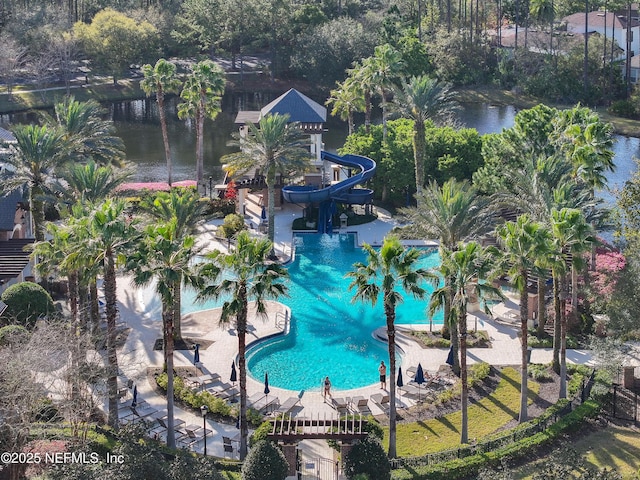 community pool with a water slide and a patio area