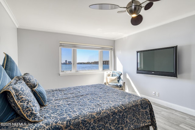 bedroom featuring crown molding, wood finished floors, and baseboards