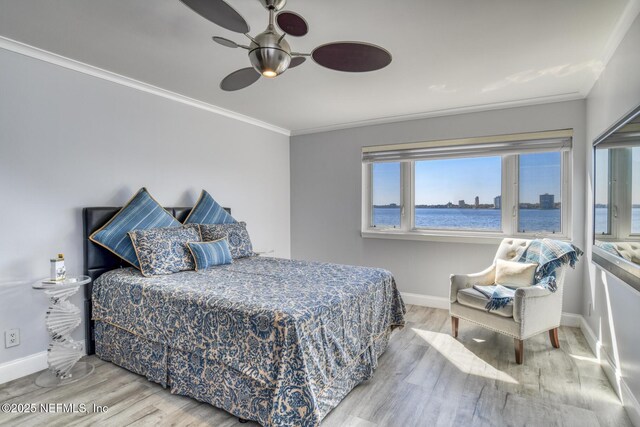 bedroom with ceiling fan, wood finished floors, baseboards, and ornamental molding