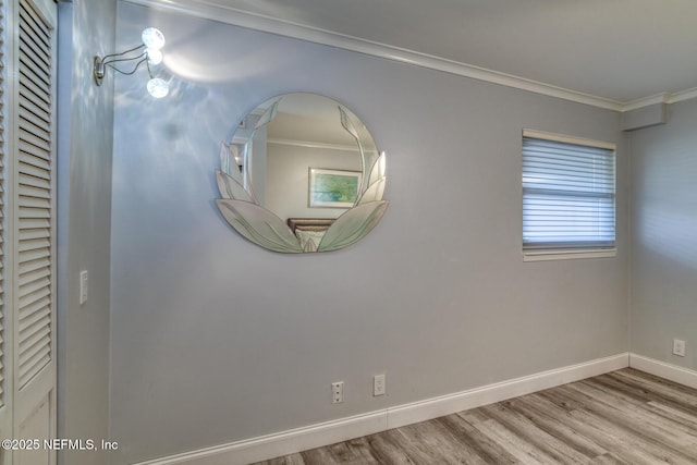 room details with wood finished floors, baseboards, and ornamental molding