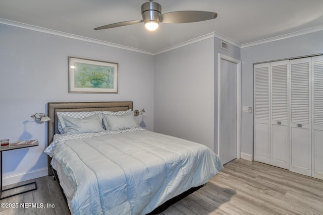 bedroom with baseboards, visible vents, light wood-type flooring, and ornamental molding