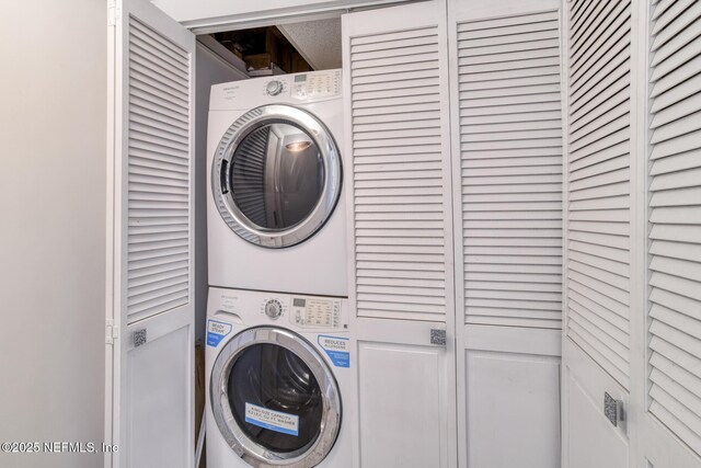 laundry area featuring laundry area and stacked washer and clothes dryer