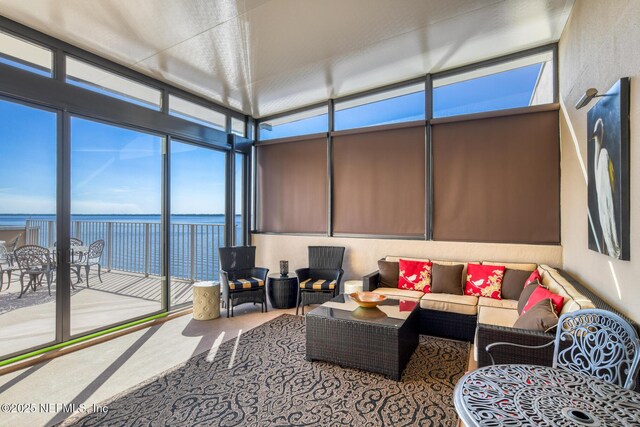 sunroom / solarium with a water view