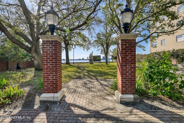 view of gate featuring a lawn