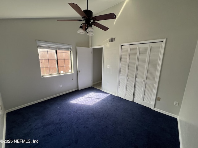 unfurnished bedroom with baseboards, visible vents, carpet flooring, high vaulted ceiling, and a closet