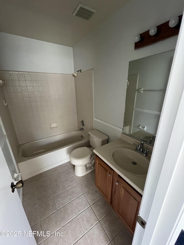 bathroom with bathing tub / shower combination, visible vents, toilet, vanity, and tile patterned floors