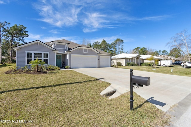 view of front of property with an attached garage, driveway, and a front yard