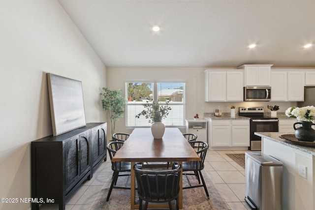 dining space with recessed lighting, vaulted ceiling, and light tile patterned floors