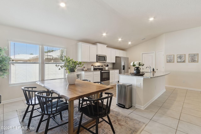 dining room featuring light tile patterned floors, vaulted ceiling, baseboards, and recessed lighting