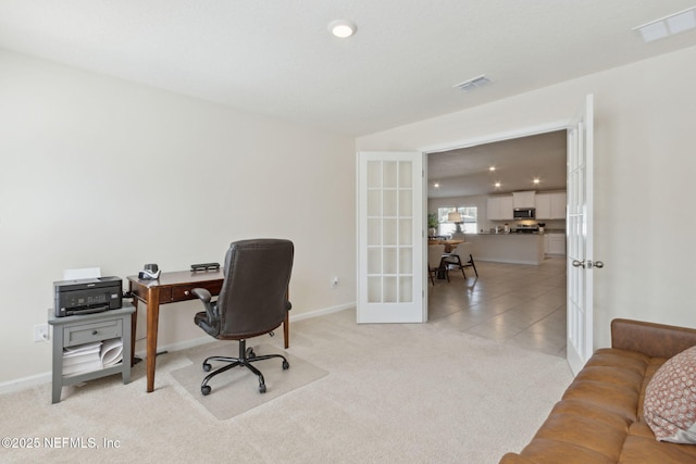 office area featuring french doors, light tile patterned flooring, visible vents, and light colored carpet