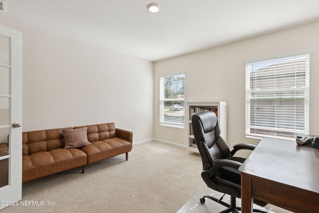 office with visible vents, baseboards, and carpet flooring