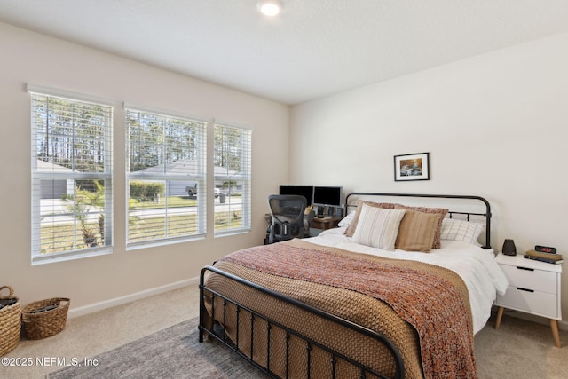 carpeted bedroom featuring baseboards